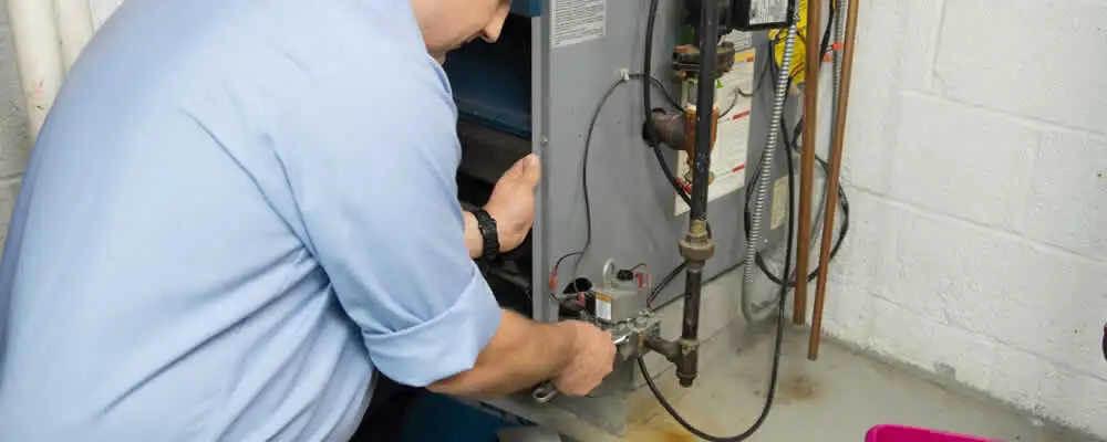 Furnace repair technician inspecting and servicing a home heating system in Berkeley, CA