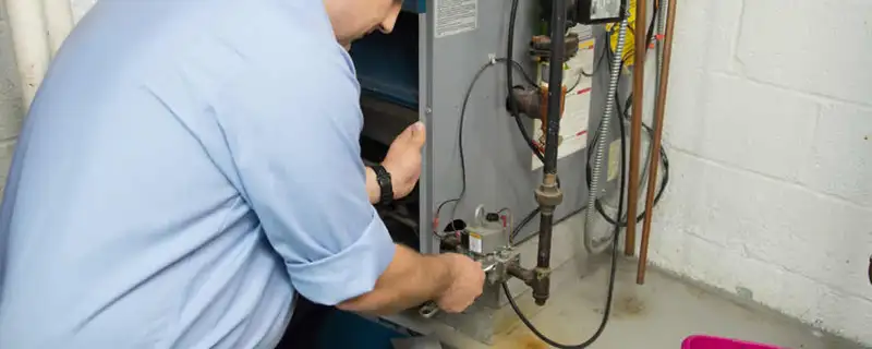 Furnace repair technician inspecting and servicing a home heating system in Berkeley, CA