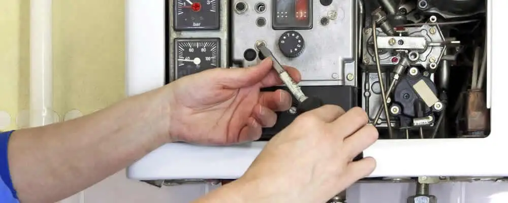 Heating repair technician adjusting boiler controls and components in Berkeley, CA