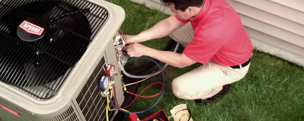HVAC technician servicing an outdoor air conditioner unit in Berkeley, CA