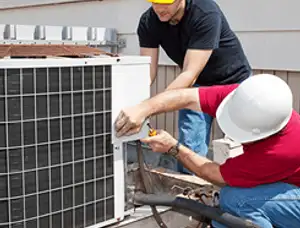 HVAC technicians repairing an outdoor AC unit on a rooftop in Berkeley, CA