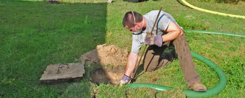 Septic pumping technician servicing a residential septic tank in Berkeley, CA