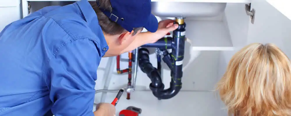 Plumber repairing under-sink drain pipes and fittings in Berkeley, CA